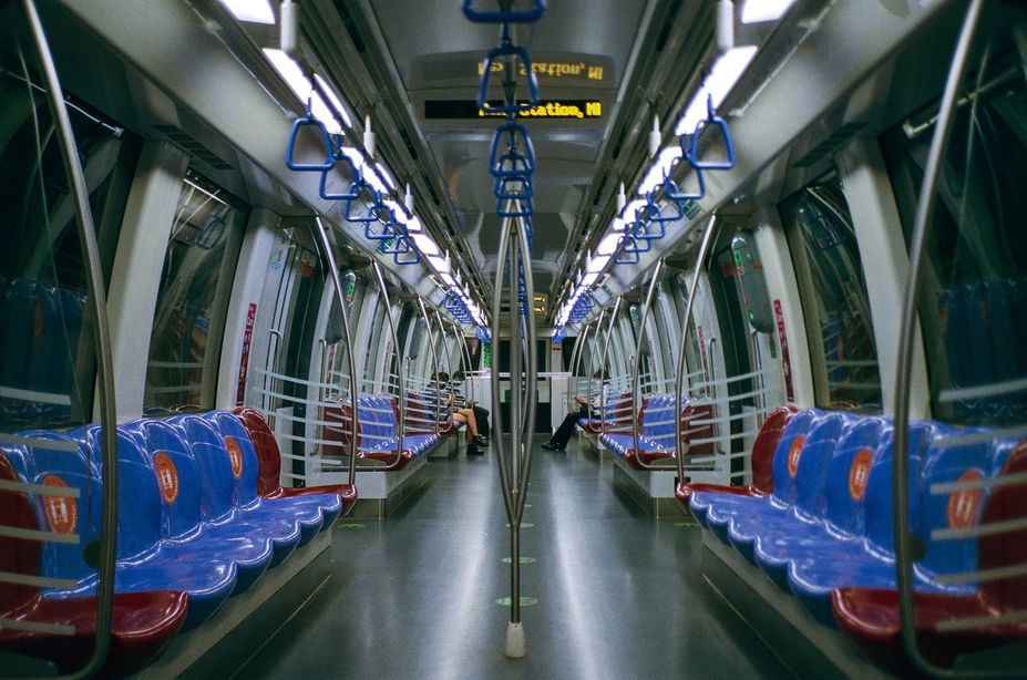Inside a subway car, the seats are adorned in a calming shade of blue, providing a pleasant commuting experience. Inside a subway car, the seats are adorned in a calming shade of blue, providing a pleasant commuting experience.