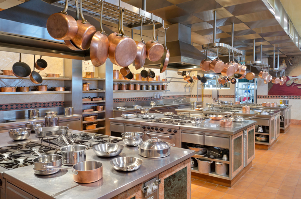 A well-equipped commercial kitchen showcasing an array of pots and pans, ideal for efficient cooking and food preparation. A well-equipped commercial kitchen showcasing an array of pots and pans, ideal for efficient cooking and food preparation.