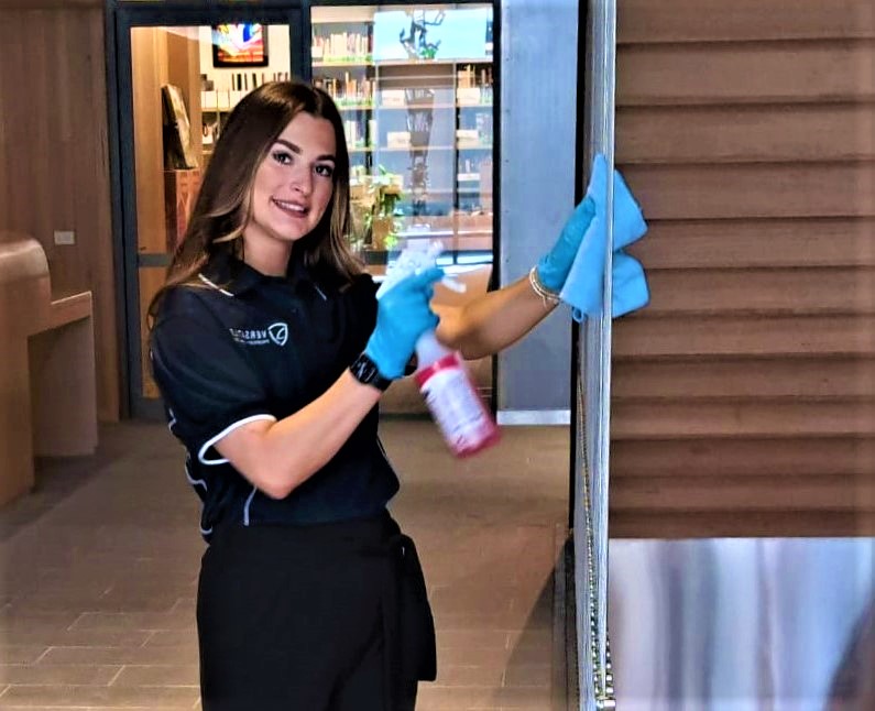 Expert Commercial Janitorial Services for Offices and Business Facilities Professional janitor with cleaning cart performing commercial cleaning in an office building.