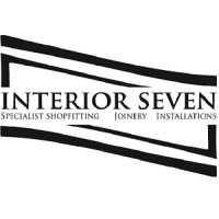 ​Interior Seven team installing custom joinery in a retail store, showcasing their expert shop fitting services.